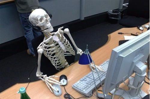 Skeleton at desk/computer/work